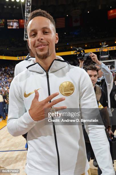 Stephen Curry of the Golden State Warriors poses for a photo with his championship ring before the game against the Houston Rockets on October 17,...
