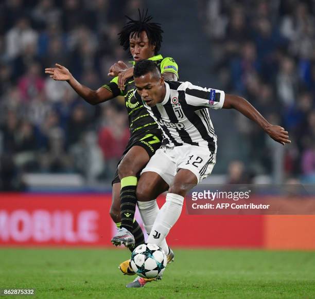 Juventus' defender from Brazil Alex Sandro fights for the ball with Sporting's forward Gelson Martins during the UEFA Champions League Group D...