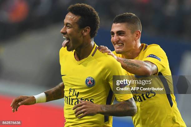 Paris Saint-Germain's Brazilian forward Neymar celebrates scoring a goal with Paris Saint-Germain's Italian midfielder Marco Verratti during the UEFA...