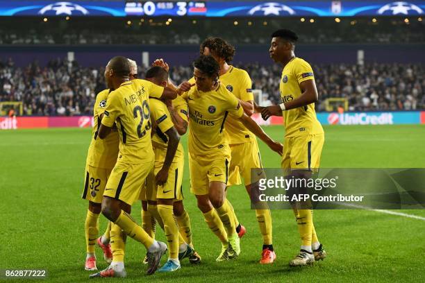 Paris Saint-Germain's players celebrate Brazilian forward Neymar after he scored the 3-0 goal during the UEFA Champions League Group B football match...
