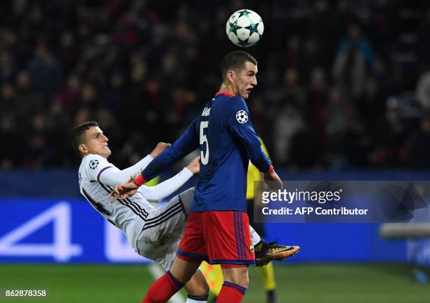 Basel's forward from Norway Mohamed Elyounoussi and CSKA Moscow's defender from Russia Viktor Vasin vie for the ball during the UEFA Champions League...