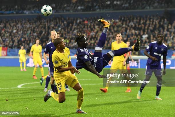 Paris Saint-Germain's French forward Kylian Mbappe vies with Anderlecht's Senegalese defender Serigne Mbodji during the UEFA Champions League Group B...