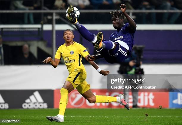 Paris Saint-Germain's French forward Kylian Mbappe vies with Anderlecht's Senegalese defender Serigne Mbodji during the UEFA Champions League Group B...