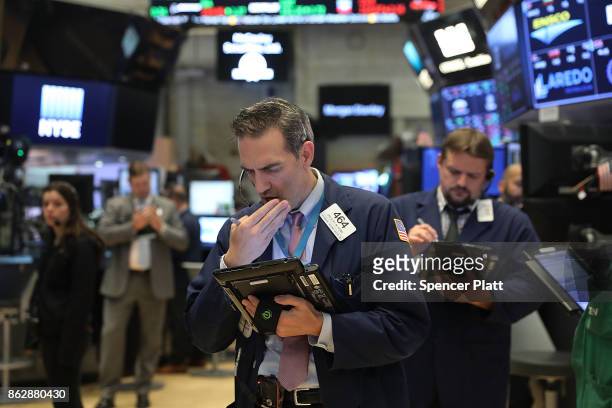 Traders work on the floor of the New York Stock Exchange on October 18, 2017 in New York City. The Dow Jones Industrial average closed at 23,157.60,...