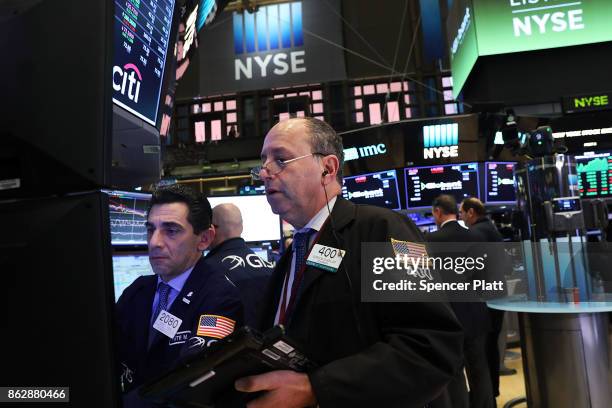 Traders work on the floor of the New York Stock Exchange on October 18, 2017 in New York City. The Dow Jones Industrial average closed at 23,157.60,...