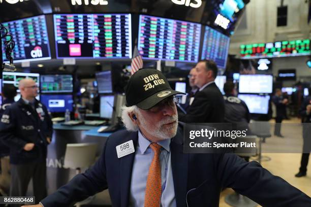 Trader wears a hat reading Dow 23,000 on the floor of the New York Stock Exchange on October 18, 2017 in New York City. The Dow Jones Industrial...