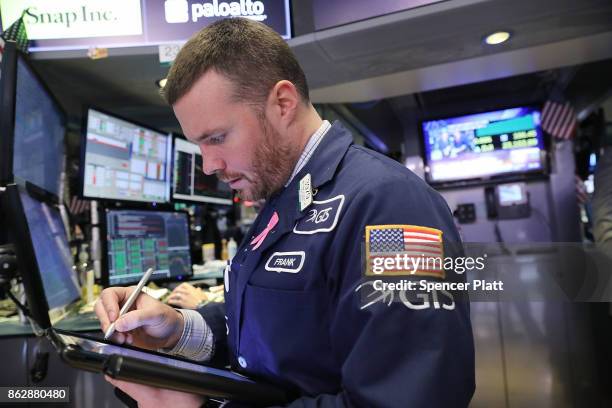 Traders work on the floor of the New York Stock Exchange on October 18, 2017 in New York City. The Dow Jones Industrial average closed at 23,157.60,...