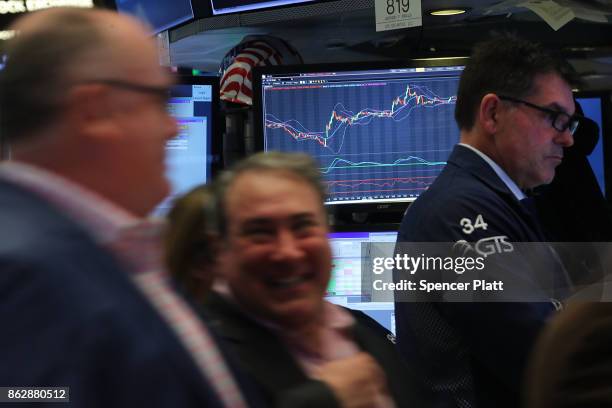 Traders work on the floor of the New York Stock Exchange on October 18, 2017 in New York City. The Dow Jones Industrial average closed at 23,157.60,...