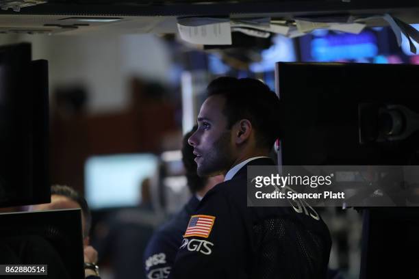 Trader works on the floor of the New York Stock Exchange on October 18, 2017 in New York City. The Dow Jones Industrial average closed at 23,157.60,...