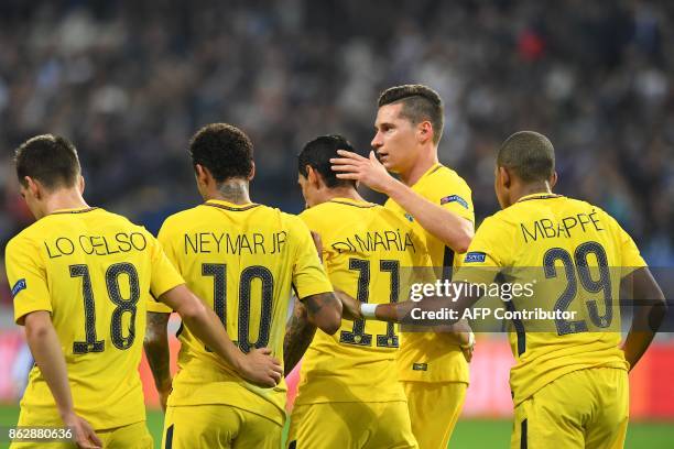 Paris Saint-Germain's players celebrat Argentinian forward Angel Di Maria after he scored a goal during the UEFA Champions League Group B football...
