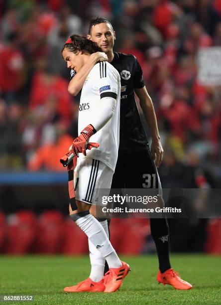 Nemanja Matic of Manchester United and Mile Svilar of Benfica embrace after the UEFA Champions League group A match between SL Benfica and Manchester...