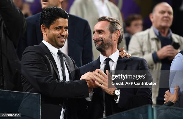 Paris Saint-Germain's Qatari president Nasser Al-Khelaifi speaks with Paris Saint-Germain's assistant general manager Jean-Claude Blanc during the...