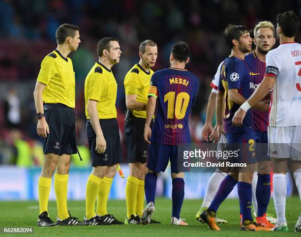 Lionel Messi of Barcelona speaks to referee William Collum after the UEFA Champions League group D match between FC Barcelona and Olympiakos Piraeus...