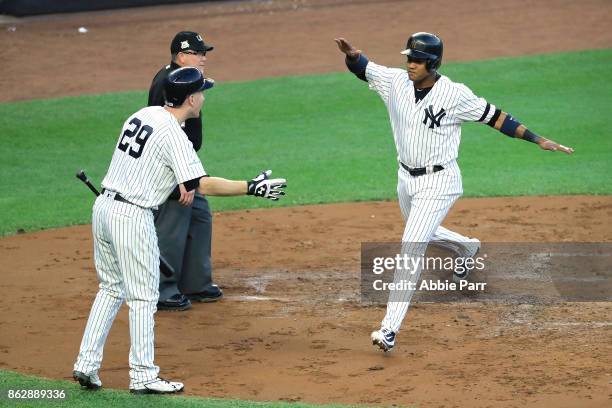 Starlin Castro of the New York Yankees celebrates with Todd Frazier after scoring on a Greg Bird single during the second inning against the Houston...