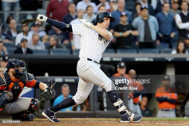 Greg Bird of the New York Yankees hits a single during the second inning scoring Starlin Castro against the Houston Astros in Game Five of the...