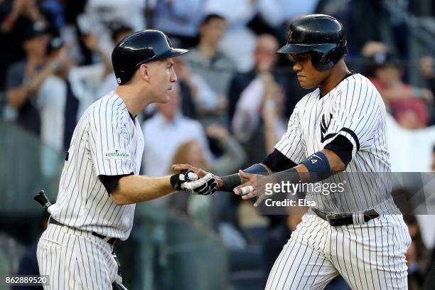 Starlin Castro of the New York Yankees celebrates with Todd Frazier after scoring on a Greg Bird single during the second inning against the Houston...