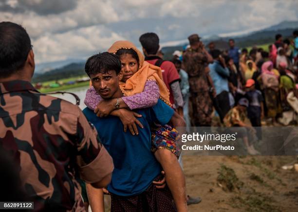 Rohingya Muslim husband is asking to take her sick wife to Hospital at Palongkhali in Cox's Bazar, Bangladesh on October 17, 2017. 15000 fled from...