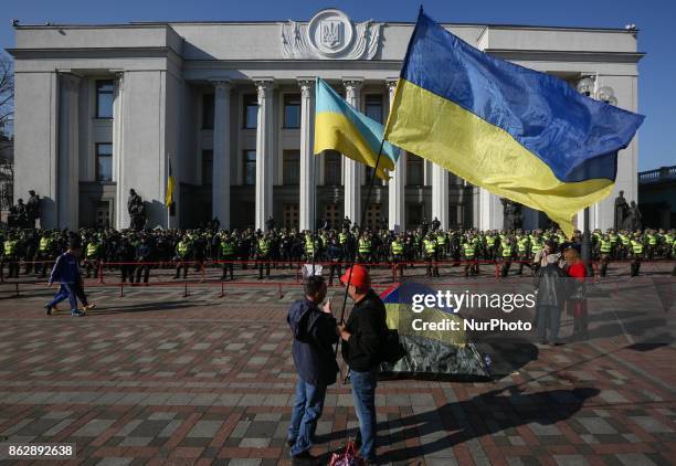 Protesters holding Ukrainian national flags stand in front of Ukrainian Parliament in Kyiv, Ukraine, Oct.18, 2017. Dozens Ukrainians set up a tent...