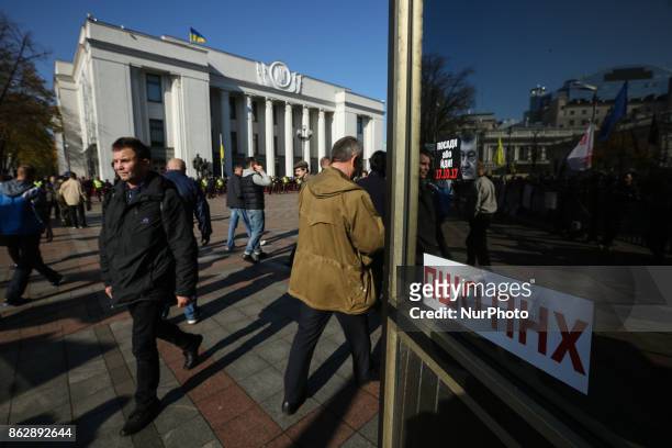 The sticker which says &quot;Poroshenko - get out&quot; is seen sticked to a window in front of Ukrainian Parliament in Kyiv, Ukraine, Oct.18, 2017....