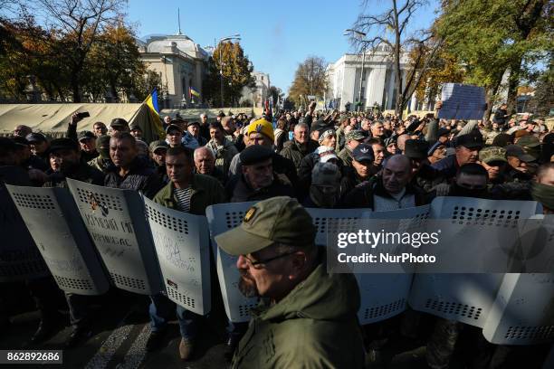 Protesters guard holds atheir shields together as they prepare for possible police attack on a camp in front of Ukrainian Parliament in Kyiv,...