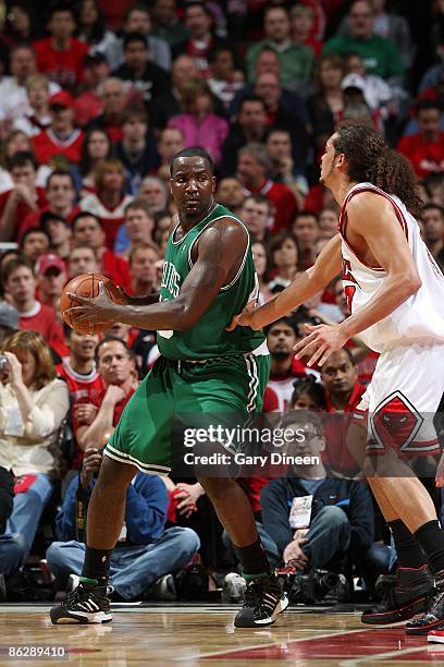 Kendrick Perkins of the Boston Celtics drives the ball against Joakim Noah of the Chicago Bulls in Game Four of the Eastern Conference Quarterfinals...