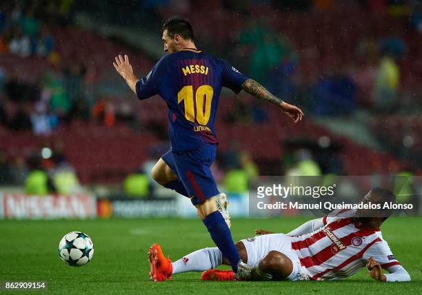 Lionel Messi of Barcelona is tackled by Alaixys Romao of Olympiakos during the UEFA Champions League group D match between FC Barcelona and...
