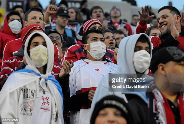 Soccer fans wear protective masks during a match between the Chicago Fire and Club America from Mexico at Toyota Park at April 29, 2009 in...