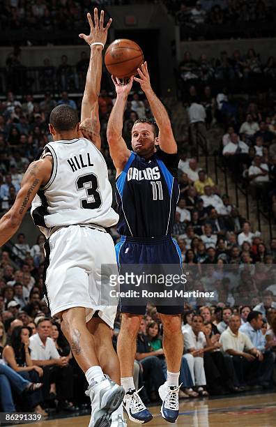 Guard Jose Juan Barea of the Dallas Mavericks takes a shot against George Hill of the San Antonio Spurs in Game Five of the Western Conference...