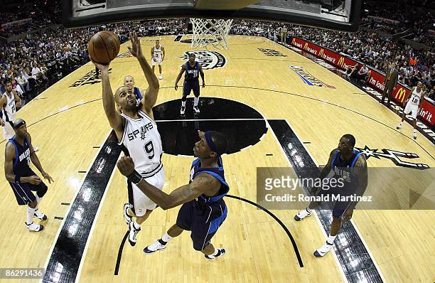Guard Tony Parker of the San Antonio Spurs takes a shot against Josh Howard of the Dallas Mavericks in Game Five of the Western Conference...