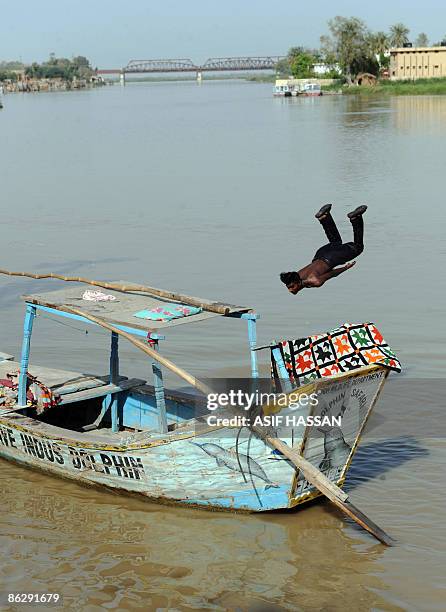 To go with "Pakistan-environment-fish-water, FEATURE by Hassan Mansoor" In this picture taken on April 4 A Pakistani youth jumps in the River Indus...