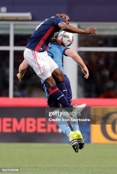 New England Revolution defender Benjamin Angoua heads the ball over New York City FC midfielder Thomas McNamara during a match between the New...