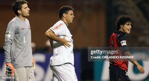 Brazilian soccer player Ronaldo of Corintians reacts after colliding with Marcelo Azevedo of Atletico Paranaense during a match valid for the...