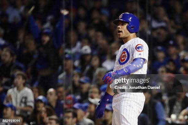 Willson Contreras of the Chicago Cubs reacts to hitting a home run in the second inning against the Los Angeles Dodgers during game four of the...