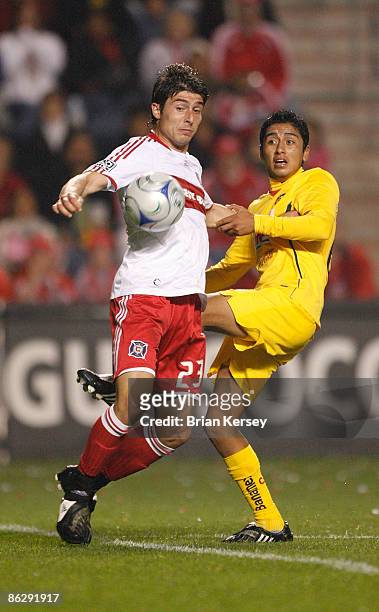 Stefan Dimitrov of the Chicago Fire and Ademar Rodriguez of Club America do for the ball during the second half at Toyota Park on April 29, 2009 in...