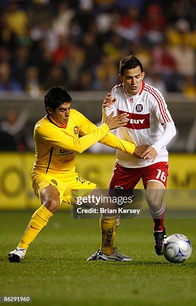 Marco Pappa of the Chicago Fire challenges Alejandro Arguello of Club America at Toyota Park on April 29, 2009 in Bridgeview, Illinois. Club America...