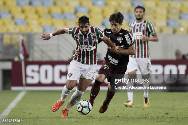 Henrique Dourado of Fluminense battles for the ball with Rodrigo Caio of Sao Paulo during the match between Fluminense and Sao Paulo as part of...