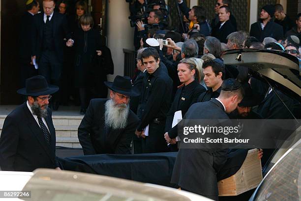 The coffin of Richard Pratt is placed in a hearse as his wife Jeanne Pratt, son Anthony Pratt and daughters Heloise Waislitz and Fiona Geminder leave...