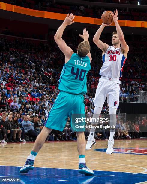 Jon Leuer of the Detroit Pistons takes a jump shot over Cody Zeller of the Charlotte Hornets during the Inaugural NBA game at the new Little Caesars...