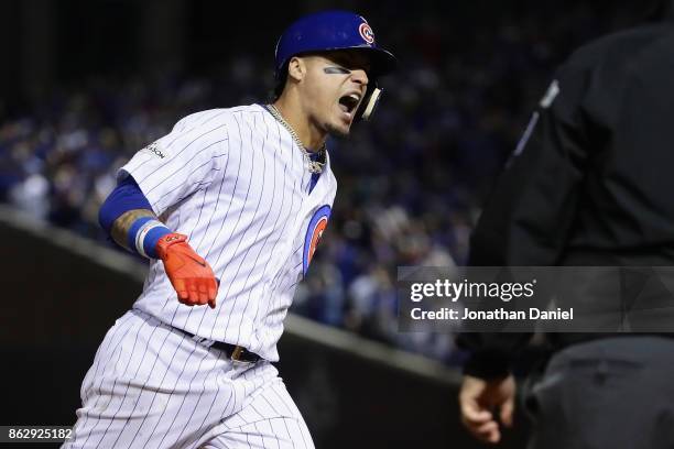 Javier Baez of the Chicago Cubs celebrates while rounding the bases after hitting a home run in the fifth inning against the Los Angeles Dodgers...