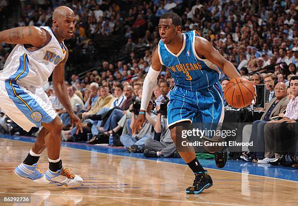 Chris Paul of the New Orleans Hornets goes to the basket against Chauncey Billups of the Denver Nuggets during Game Five of the Western Conference...