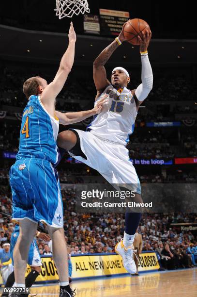 Carmelo Anthony of the Denver Nuggets takes a shot against Sean Marks of the New Orleans Hornets during Game Five of the Western Conference...