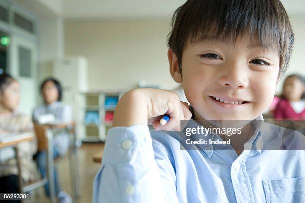 Schoolboy Smiling In Classroom Portrait, Foto de stock