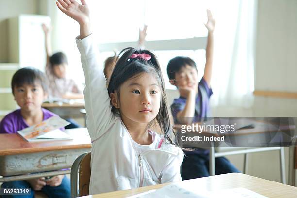 schoolgirl (8-9) raising her hand - asian kid raising hand bildbanksfoton och bilder