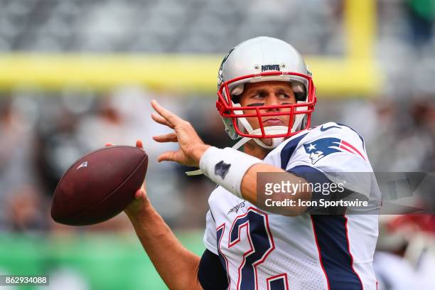 New England Patriots quarterback Tom Brady warms up prior to the National Football League game between the New York Jets and the New England Patriots...