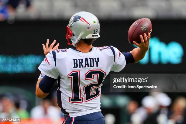 New England Patriots quarterback Tom Brady warms up prior to the National Football League game between the New York Jets and the New England Patriots...
