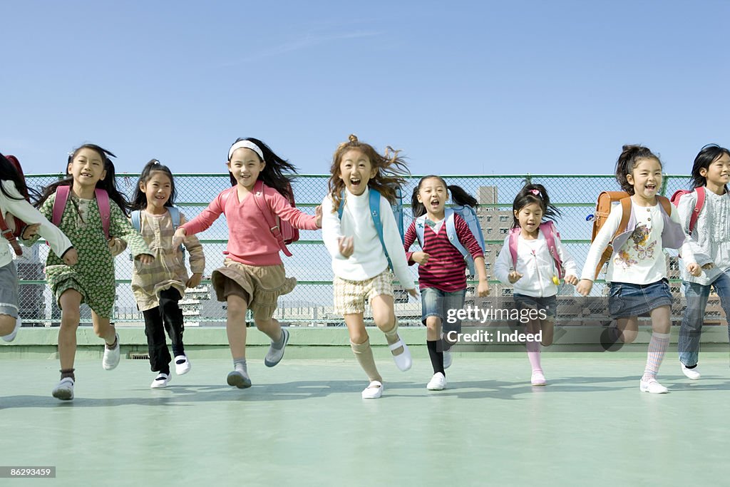 Schoolgirls (6-9) running
