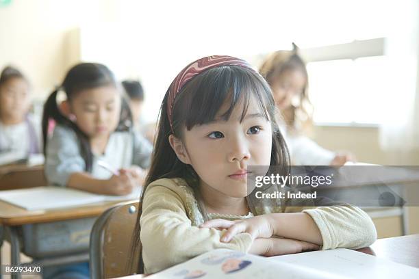 schoolgirl listening lecture in classroom - japanese elementary school bildbanksfoton och bilder