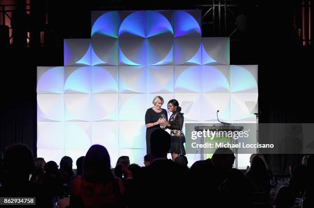 Mary Gen Ledecky accepts the Individual Sportswoman of the YearAward for daughter Katie Ledecky from Gabby Douglas during The Women's Sports...