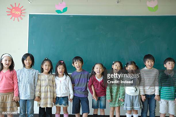 school children (6-11) singing in classroom - japanese elementary school bildbanksfoton och bilder