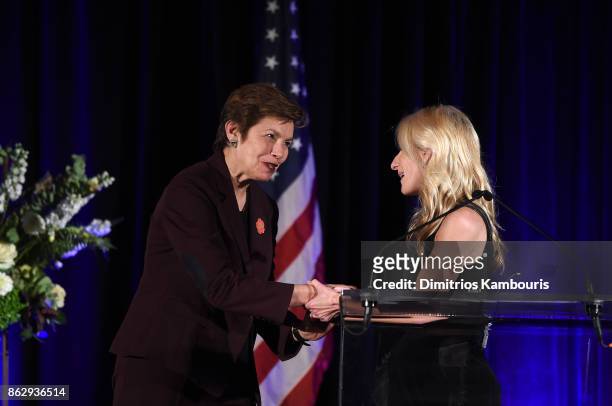 Brigadier General Loree Sutton and Board Member, Event Co-Chair Aryn Grossman greet each other on stage during "Change Begins Within: Healing The...